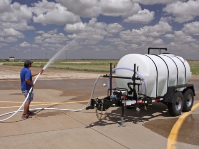 Man spraying water with the trailer hose