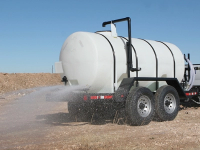A 1025 water trailer spraying water with the rear spray bar
