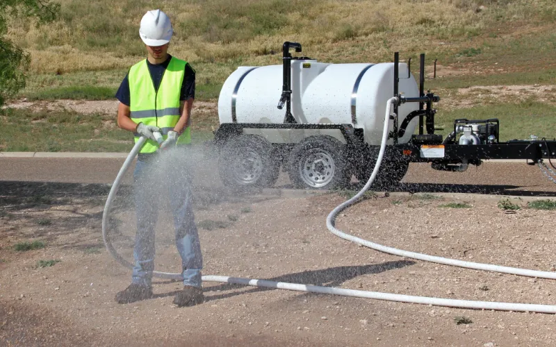 Water trailer with rear spray bar for dust control