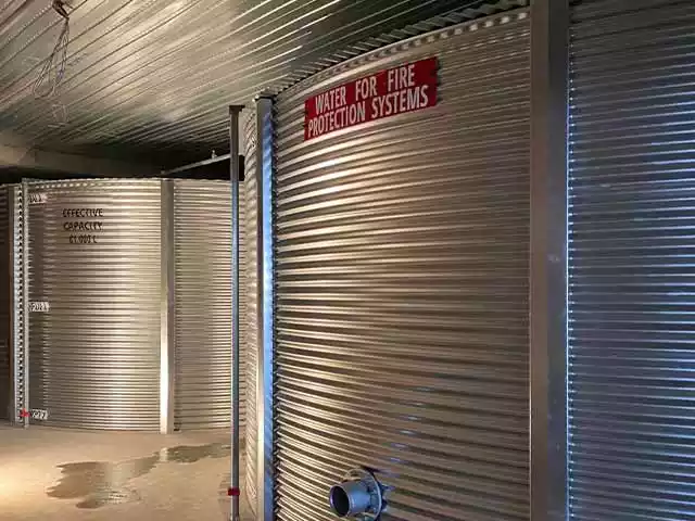 Two corrugated tanks for fire suppression inside of a building