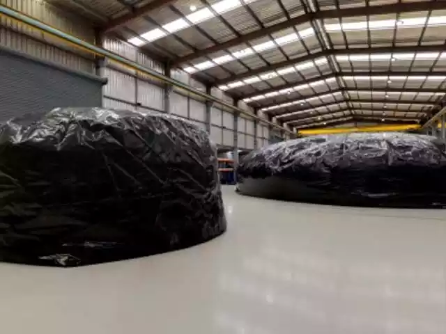 Black tank liners in a warehouse