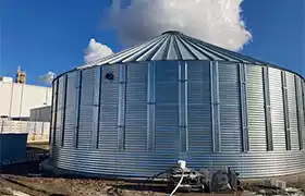 Corrugated steel tank installed next to an industrial facility