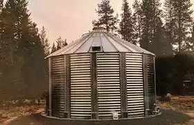 Corrugated steel tank installed in a forest