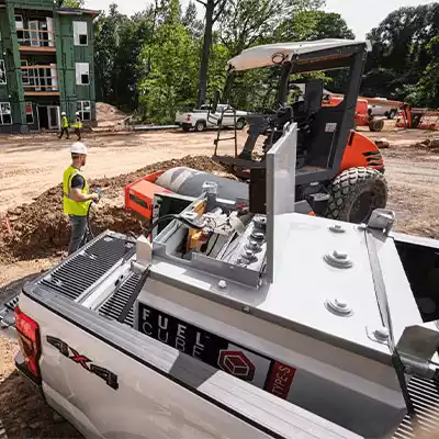 FuelCube Type S in the back of a pickup truck, refueling a piece of contruction equipment.