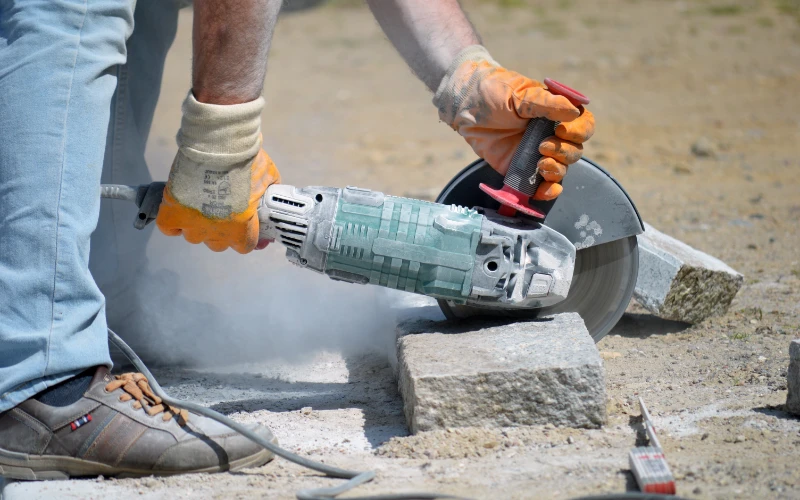 Water trailer applying water for concrete cutting dust control on a demolition site