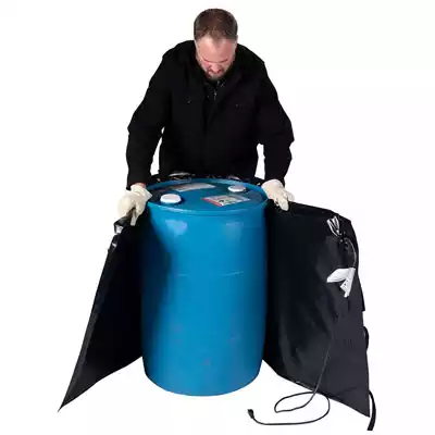 Man wrapping a heater blanket around a 55 gallon drum