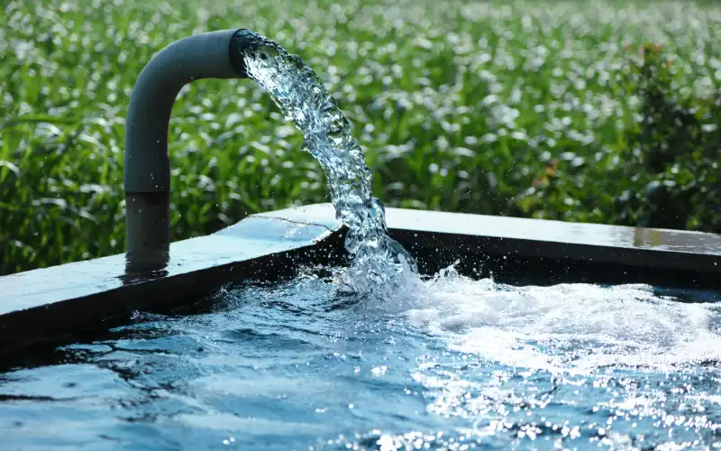 water filling a container on a farm